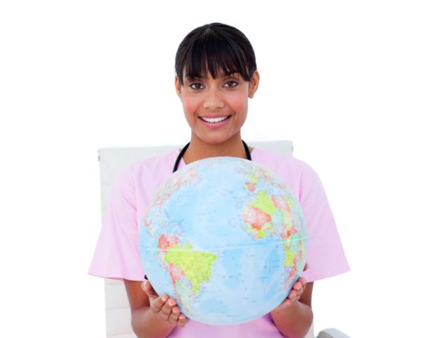 nurse who chose a travel nursing career holding a globe